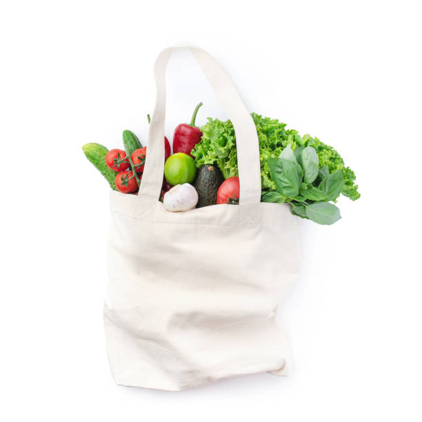 istock Linen eco bag with vegetables and herbs on a white isolated background 1394769915