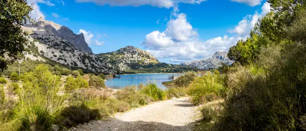 Photo of Hiking trail GR221 leads through nature reserve Serra de Tramuntana in the valley of Vall de Cuber along Torrent de l'Ofre to the hiking retreat Refugi de Cúber at artificial lake Embassament de Cuber