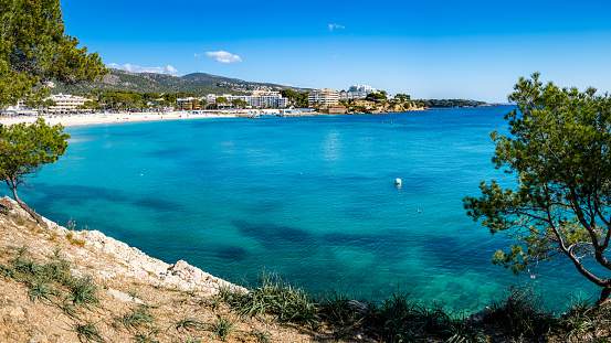 Bay of Palmanova and Porto Novo with the tourist beach Platja de Porto Novo, some hotels and small marina Club Nautico Palmanova at Mallorca in the municipality of Calvia on a sunny day in springtime.