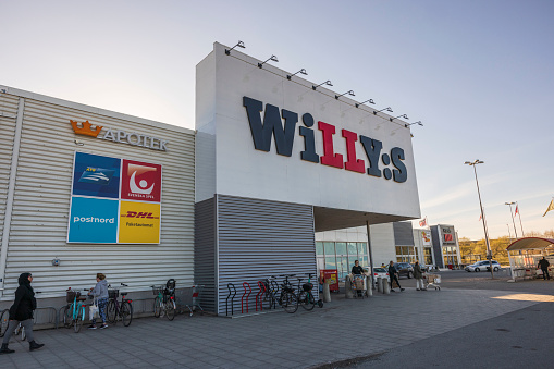 Sweden. Uppsala. 04.21.2022. Beautiful view of facade of Willy:s supermarket with people visiting supermarket.