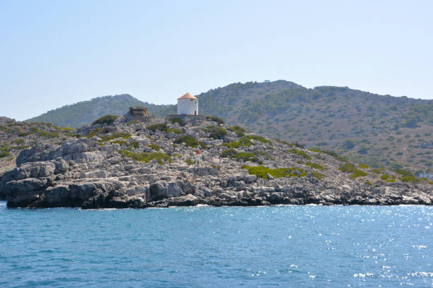 istock white windmill on lonely island in mediterranean sea 1394773330