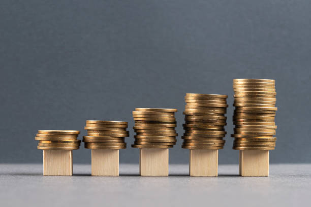 istock Wooden blocks and coins 1394773352