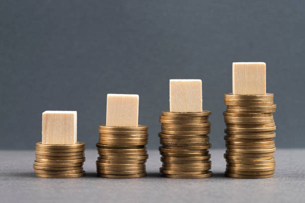 istock Wooden blocks and coins 1394773363