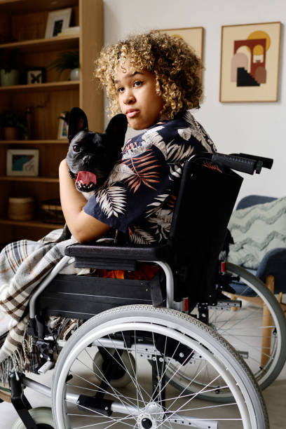 istock Girl with disability holding her pet 1394774617