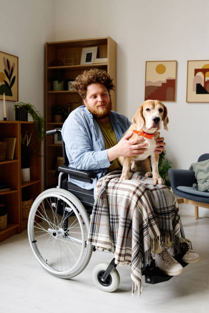 istock Man with disability spending time with service pet 1394774636