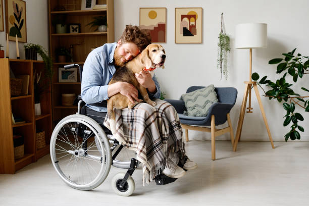 istock Man with disability comforting himself with dog 1394774647