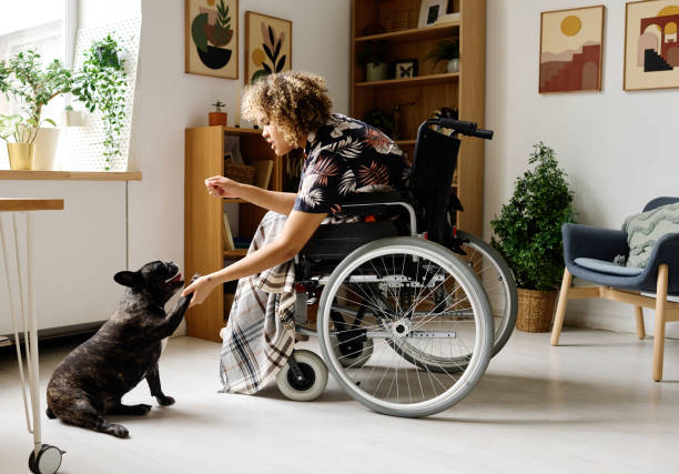 istock Woman with disability spending time with dog 1394774666