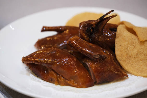 Crispy Pigeon (squab). Traditional Cantonese food close up Crispy Pigeon (squab) in plate. Traditional Cantonese cuisine squab pigeon meat stock pictures, royalty-free photos & images