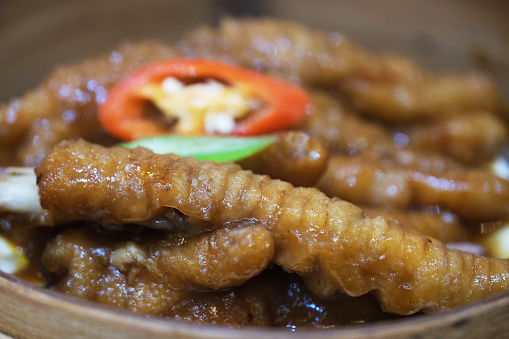 extreme close up of Abalone sauce chicken feet in steamer. Traditional Cantonese cuisine