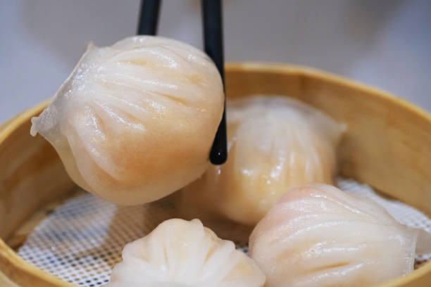 istock chopsticks picking Har gow. traditional Cantonese food 1394774798