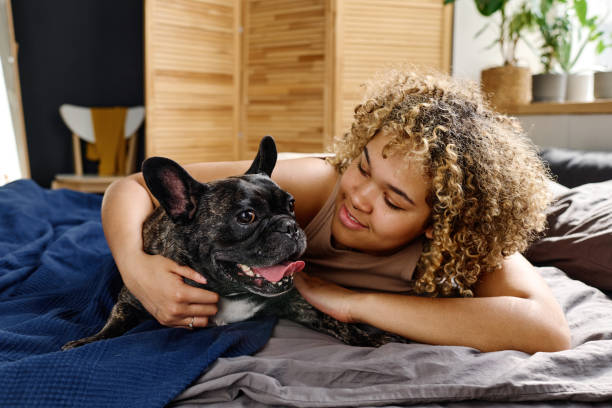 istock Woman lying on bed with her pet 1394774812