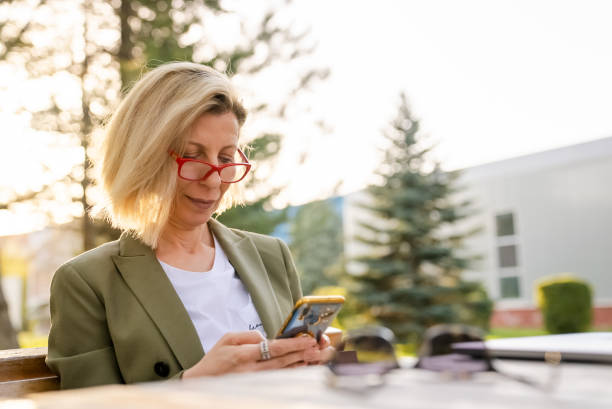 istock Casual Business Woman, outdoor, using mobile devices 1394777687