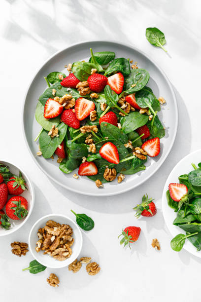 istock Strawberry and spinach salad with walnuts, top view 1394778214