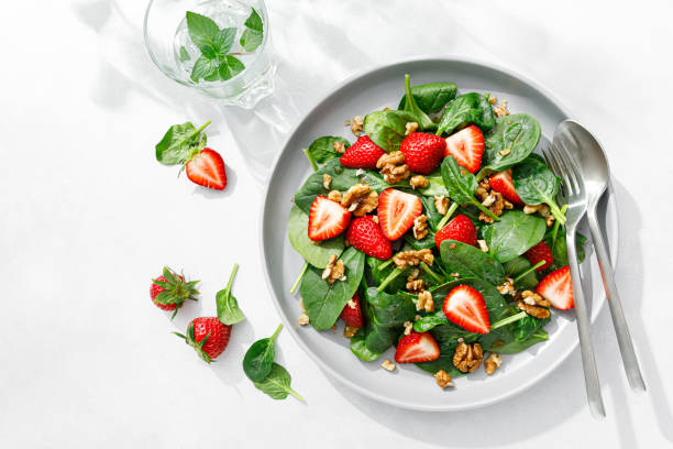 istock Strawberry and spinach salad with walnuts, top view 1394778254