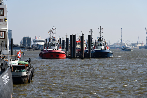 Hamburg, Germany, March 20, 2022 - Front view of a group of tugboats in the port of Hamburg