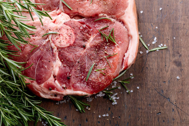 istock Raw pork with rosemary , salt and pepper. 1394783612