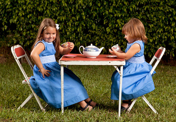 sisters having a tea party stock photo