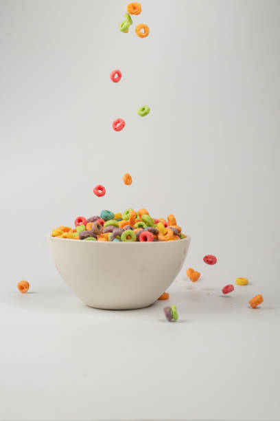 istock Colorful cereal box for morning breakfast. Corn flakes falling to the white bowl. Motion. 1394784235
