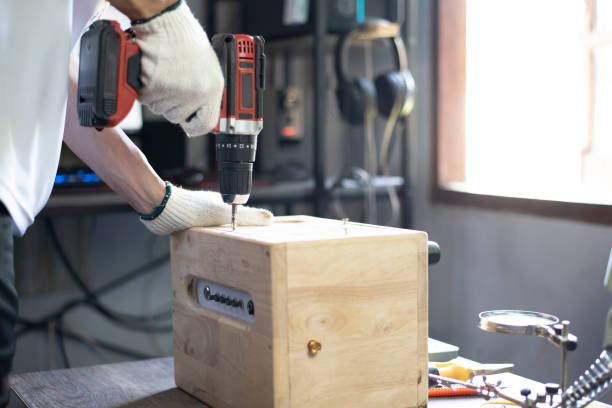 istock DIY work at home, Man screwing speaker cabinet, Close up. 1394784426