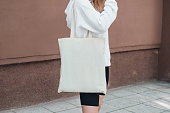 istock Young woman with white cotton bag on her shoulder. 1394784646