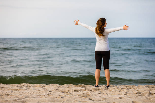 istock Young woman walking at seaside 1394784784