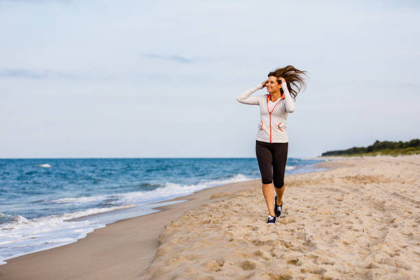 istock Young woman walking at seaside 1394785315