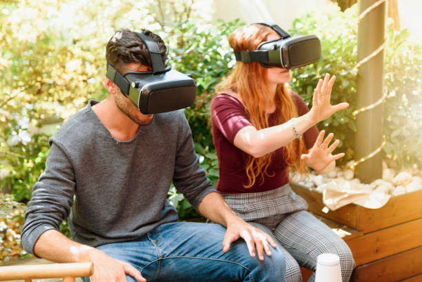 istock Couple trying virtual reality visors on terrace 1394785420