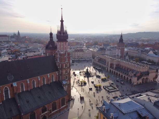 The main square of the old town of Krakow with the St. Mary’s Basilica, the Adam Mickiewicz Monument, Cloth Hall and the free-standing Town Hall Tower.