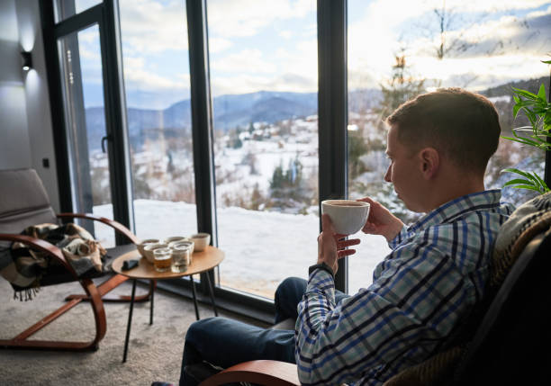 istock Man enjoying weekends inside contemporary cottage. 1394786919
