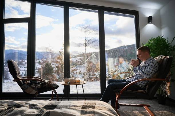 istock Man enjoying weekends inside contemporary cottage. 1394786923