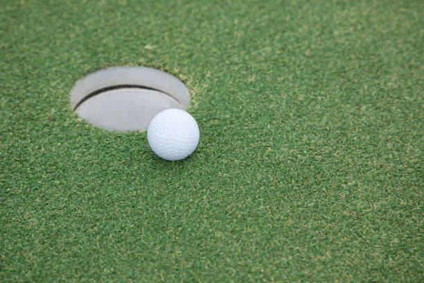 istock golf ball on lip of cup 1394787705