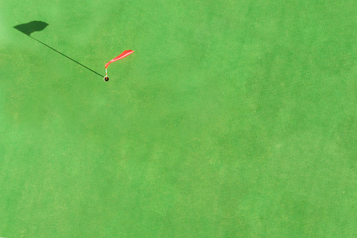 Close-up photo of playing golf in the professional club outdoors with sports equipment on the green grass with the ball.