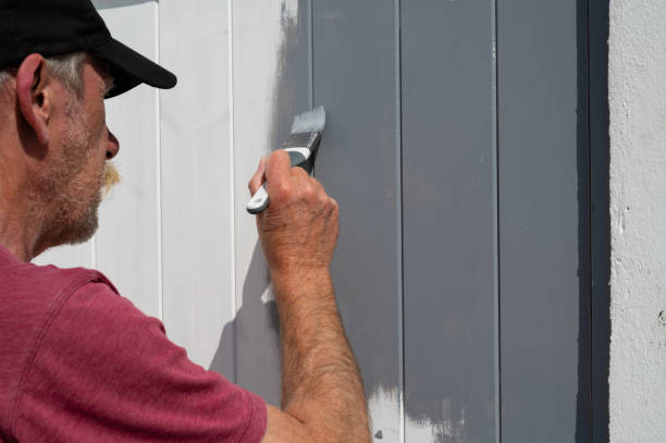 istock Senior man painting a garden gate 1394788160