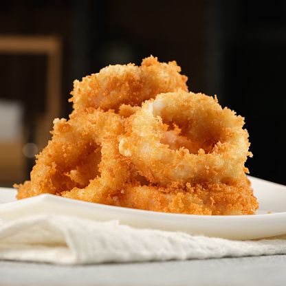 Squid rings in batter on a white plate
