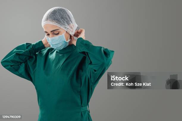 Portrait Of An Indian Woman In Surgical Wear Stock Photo - Download Image Now - Green Color, Medical Scrubs, Portrait