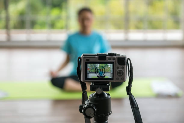 istock Sport influencer yoga practice on camera to live streaming online 1394792159
