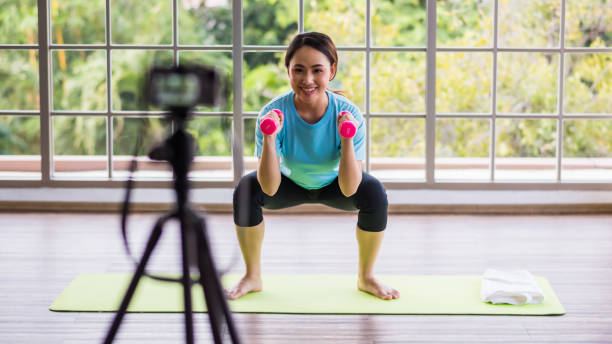istock Fitness trainer record dumbbell exercise to live online 1394792175