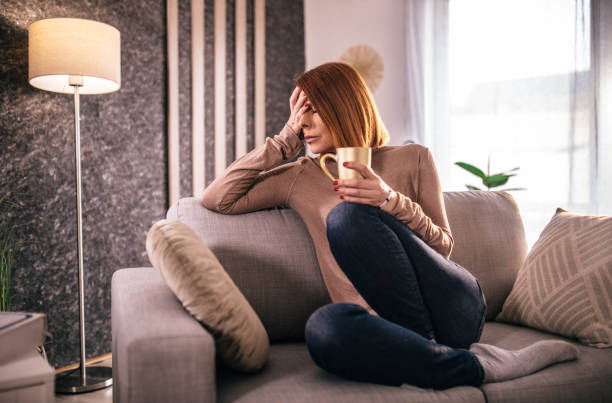istock depressed woman at home using smartphone and laptop 1394794666