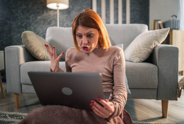 istock depressed woman at home using smartphone and laptop 1394794761