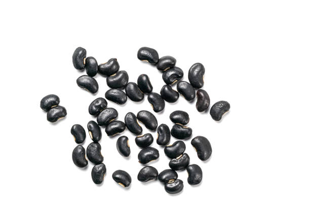 istock Top view of uncooked black beans isolated on white background. 1394795549