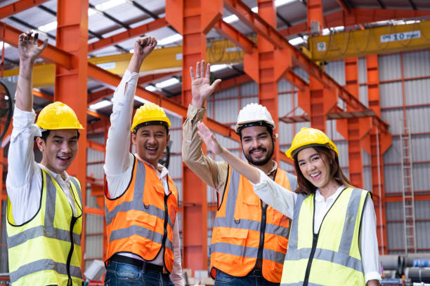 istock Asian people group  worker with supervisor holding hand to cheer up and encourage before working at industrial factory site. Teamwork, labor brainstorm or group working concept. 1394795755