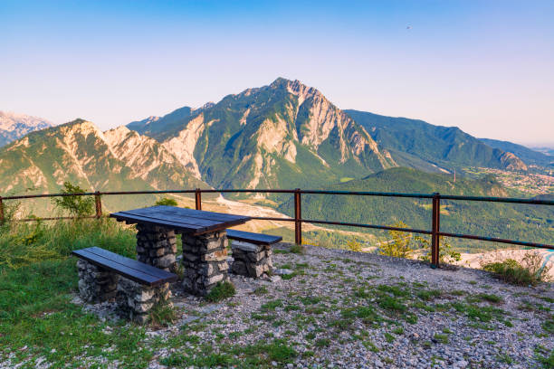 Beautiful rest place high in the mountains. Beautiful rest place high in the mountains. Stone bench and table with mountain view. Bordano, Italy gemona del friuli stock pictures, royalty-free photos & images
