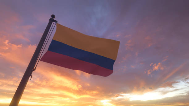 Colombia Flag on Flagpole by Evening Sunset Sky stock photo