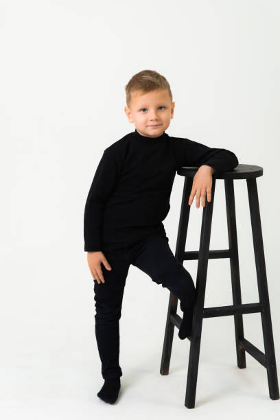 istock A little blond boy in the studio leaning against a chair 1394797201