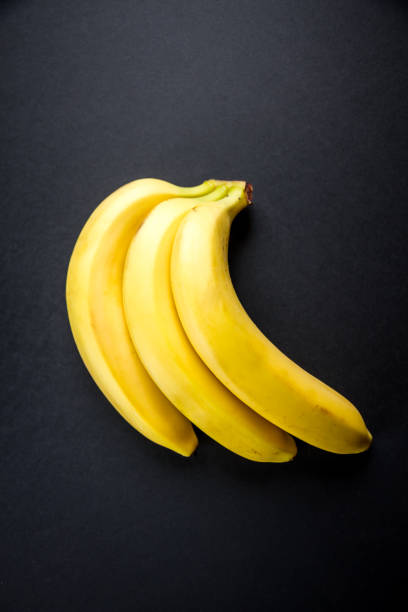 istock Bunch of bananas isolated on black background 1394800769