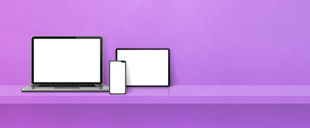 istock Laptop, mobile phone and digital tablet pc on purple wall shelf. Banner background 1394800839