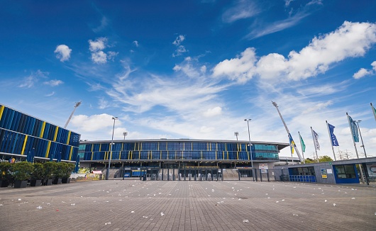 Zurich, Switzerland - May 22, 2018: View of the Zurich Hallenstadion, as well as the Zurich exhibition center behind it. In front of the indoor stadium is the ZSC Lions square with the well-known yellow fountain.