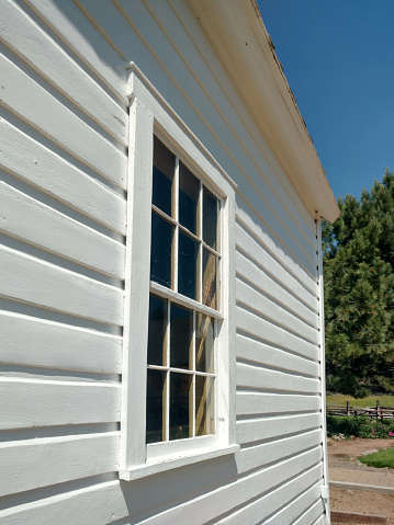 a white house window wall wooden siding board wood painted slant exterior vintage home
