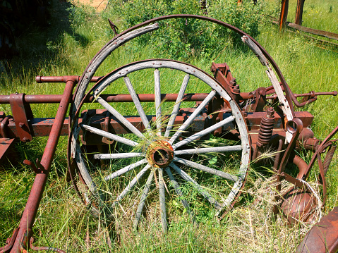 a retro rusting old vintage farm equipment machinery wheel farming harvest antique yard