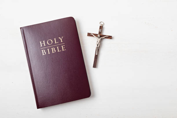 Holy Bible on white wooden table. Christian devotion, Easter celebration Holy Bible on white wooden table. Christian devotion, Easter celebration, praying, bible study concept. Top view Bible stock pictures, royalty-free photos & images